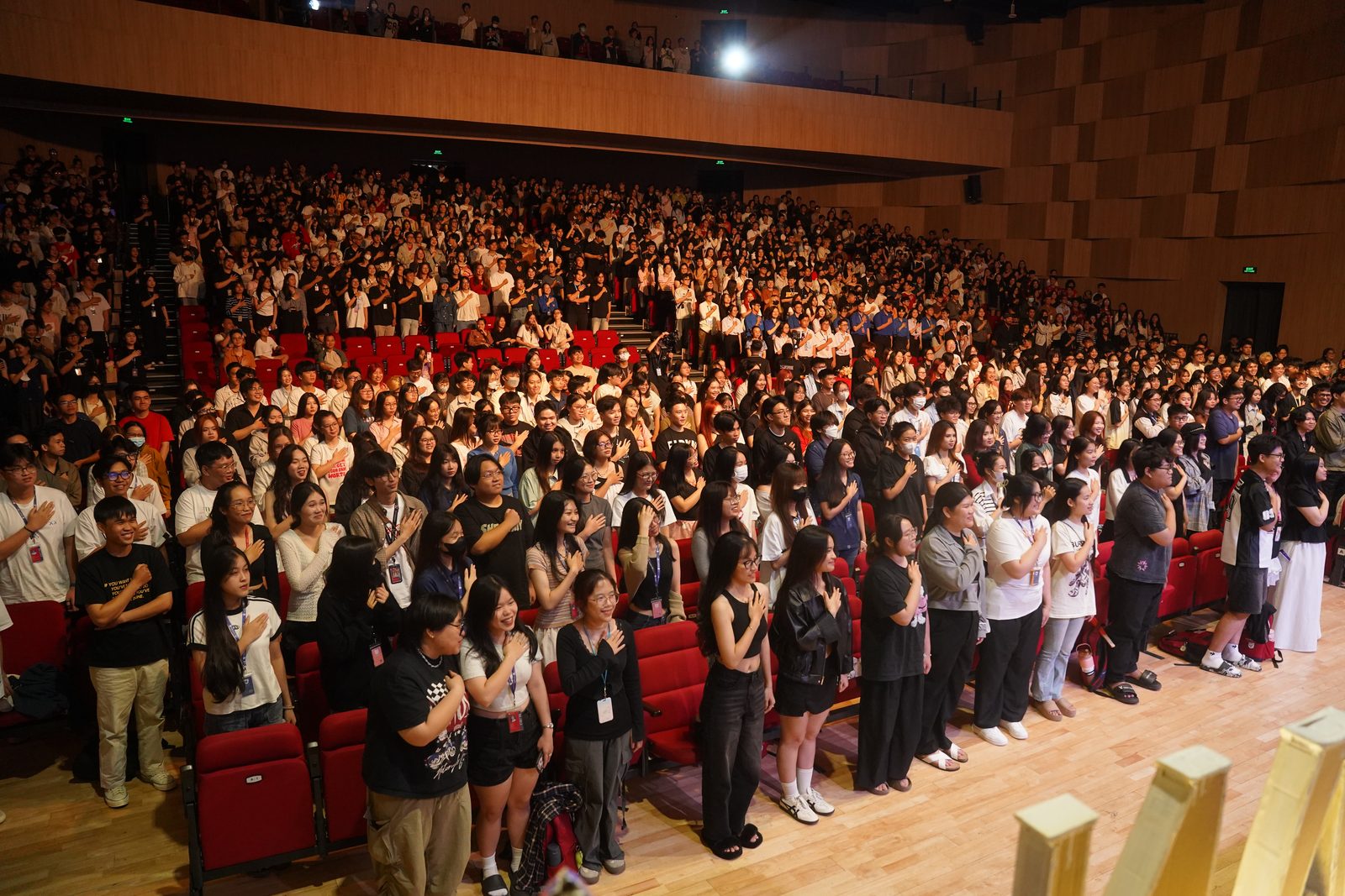 Full auditorium standing during the event